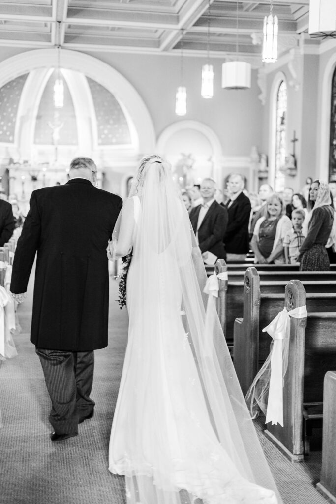 Bride Walks down with her father during her wedding ceremony at Saint Thomas church in Coeur d'Alene 