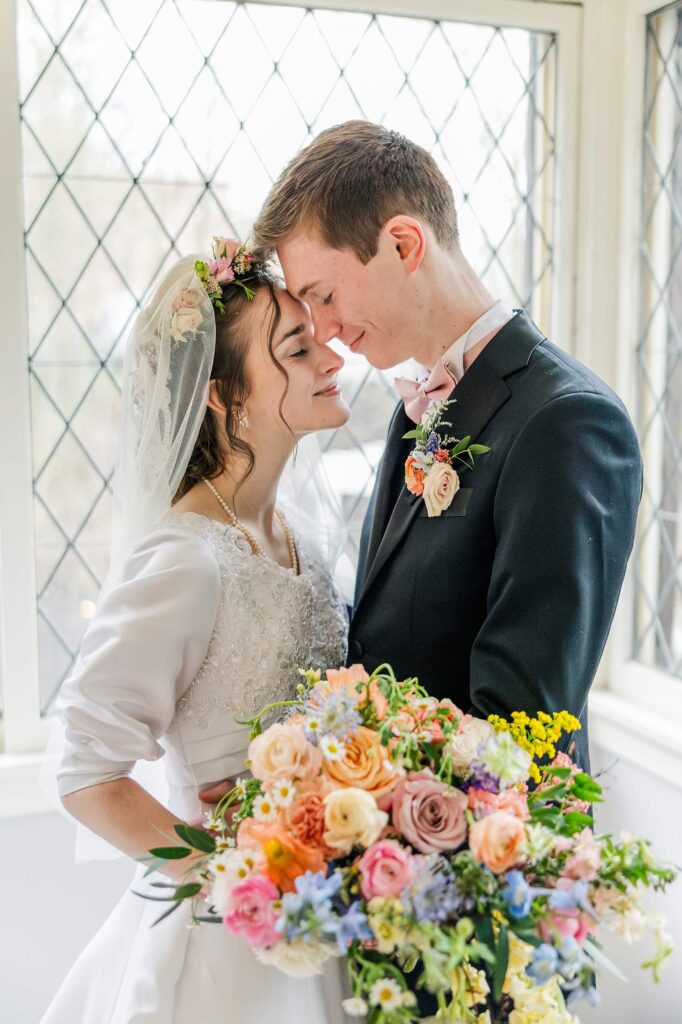 Sentimental moment between the bride and groom in the spring at the Glover Mansion