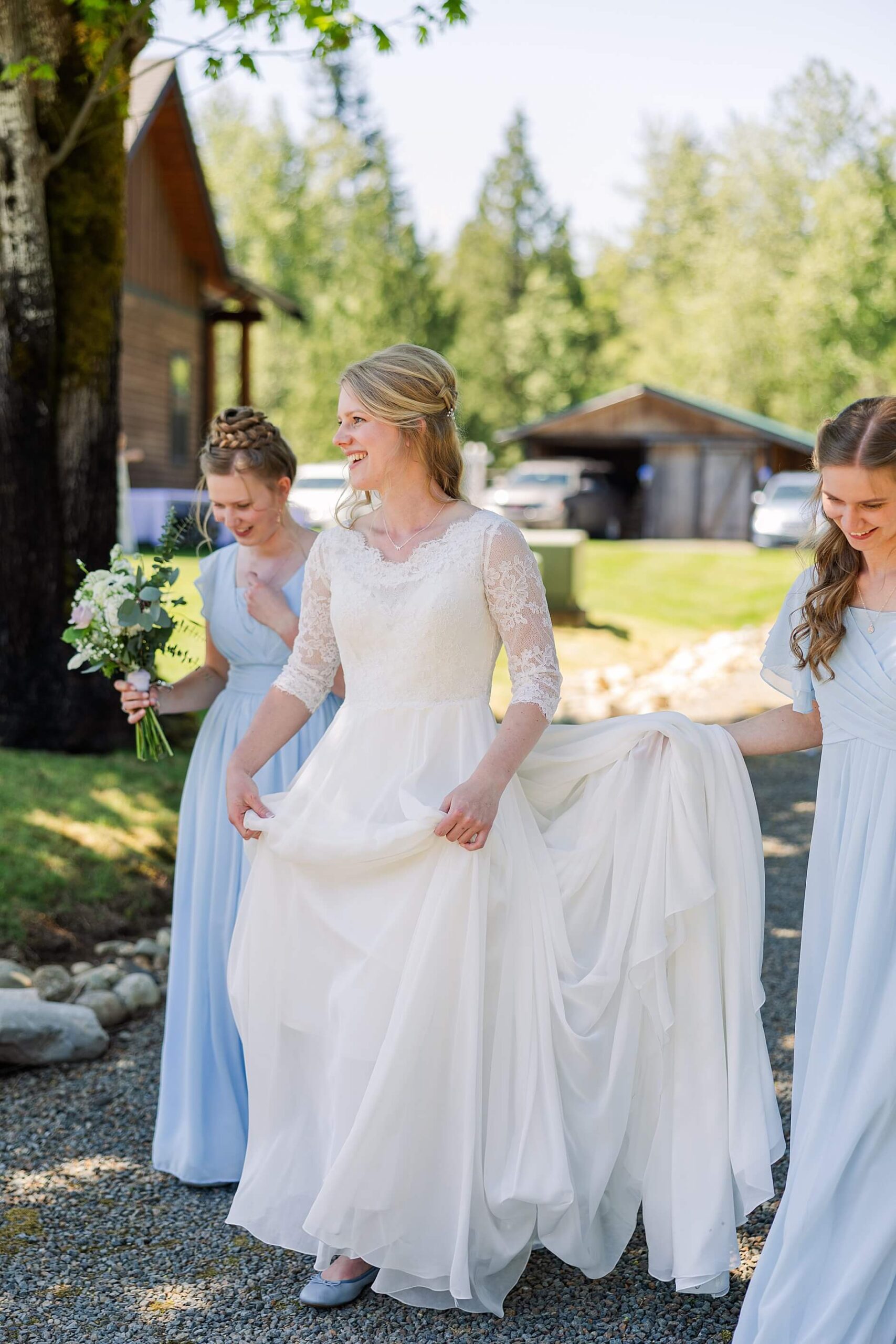 Bride Walking to her groom on her wedding day with her bridesmaids wearing blue holding her wedding train