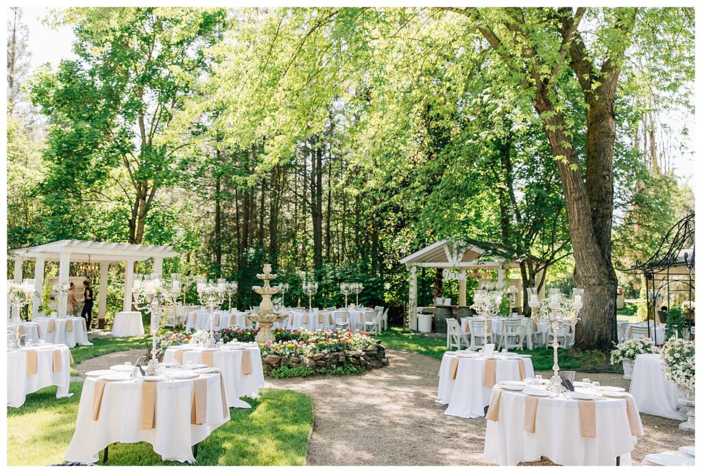 The reception space of the Belle gardens wedding venue setup with round tables with tall candelabras on tables 
