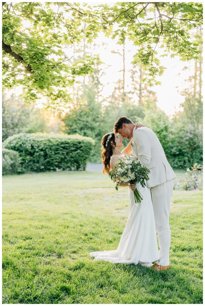 Bride and groom smile at each for their wedding day portraits 